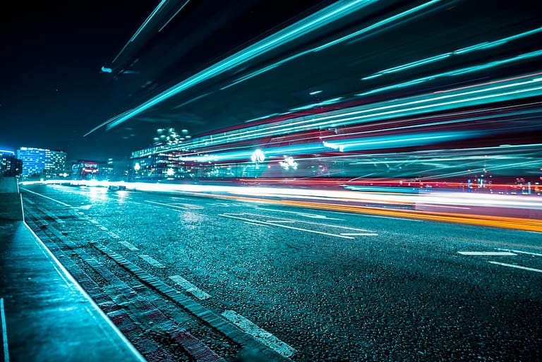 Fast-moving light trails on a city street symbolize the acceleration of hybrid sales through smart lead generation strategies.
